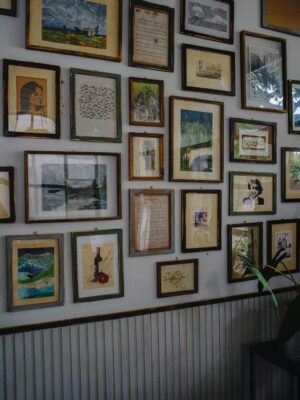 A cozy room with a collection of framed artwork and a modern industrial style.