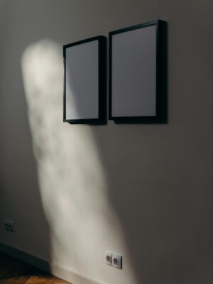 Minimalist contemporary art wall with framed poster artworks in modern interior design setting.