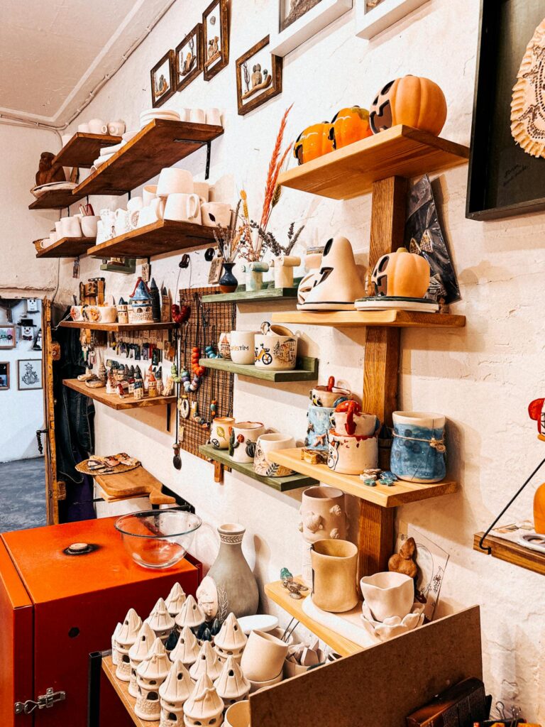Vibrant pottery and ceramics displayed in a cozy art studio corner.